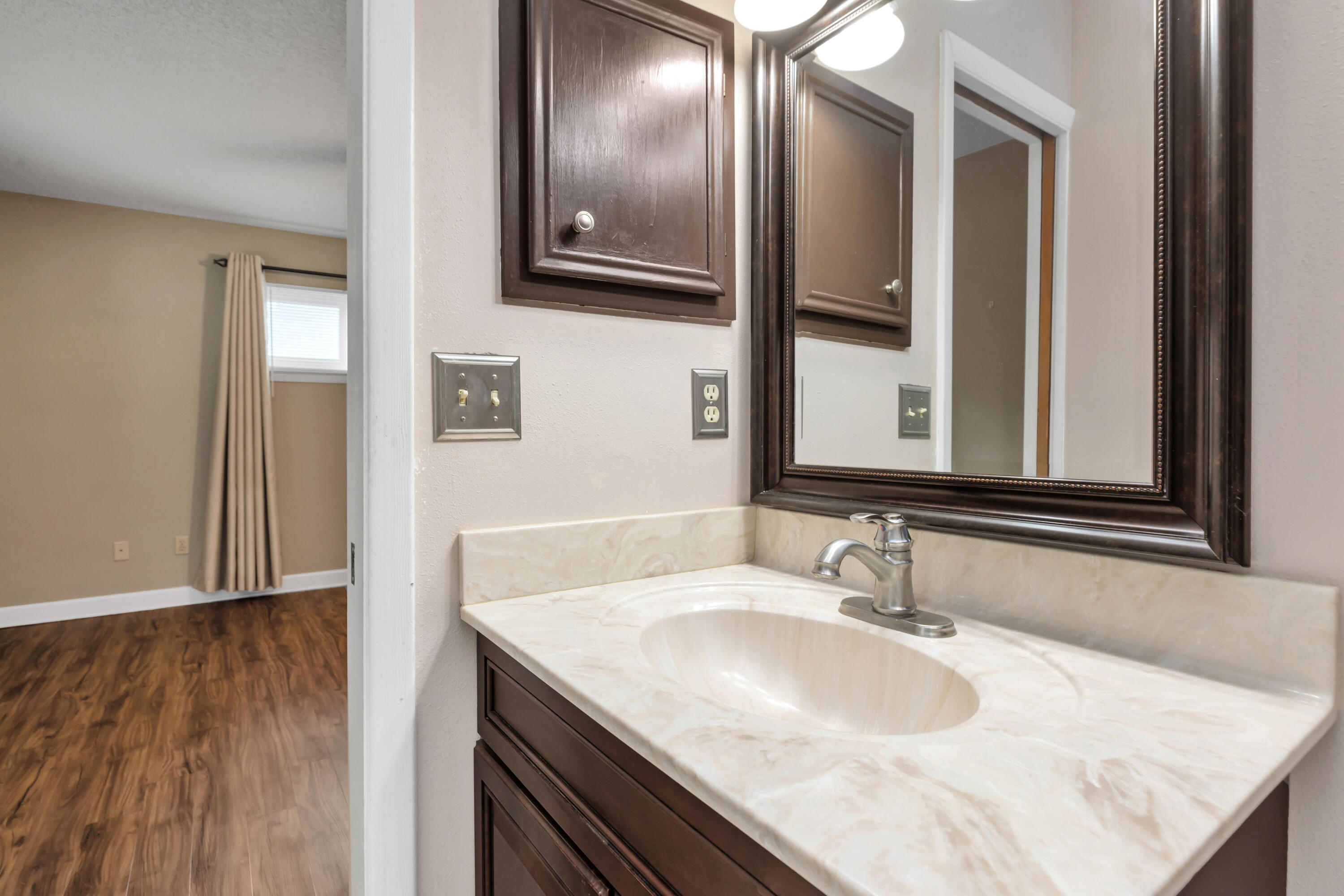 129 12th Avenue Shalimar, FL 32579 - Photo 27 of 36 a bathroom with a granite countertop sink and a mirror