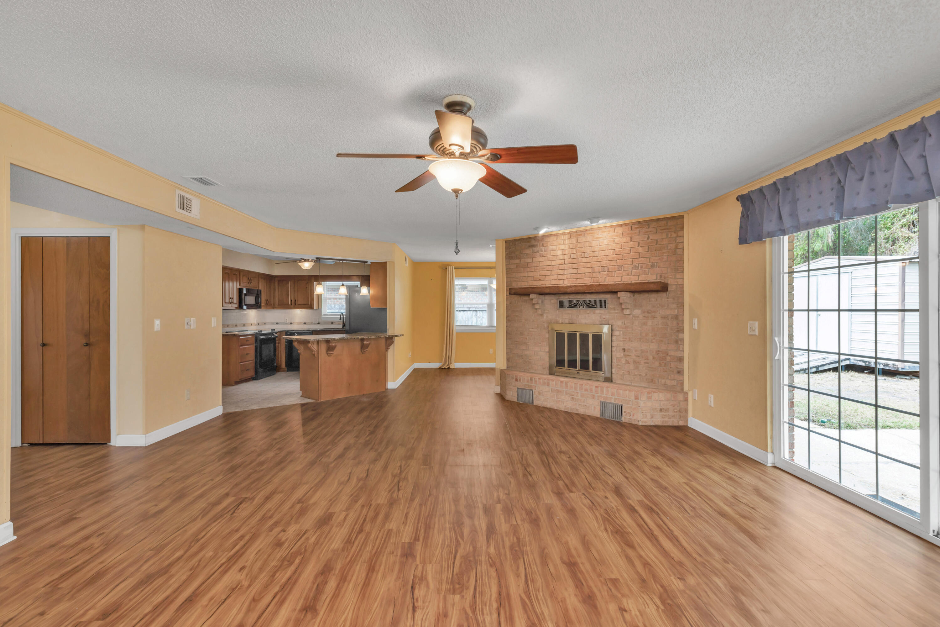 129 12th Avenue Shalimar, FL 32579 - Photo 4 of 36 a view of a kitchen with wooden floor and a kitchen