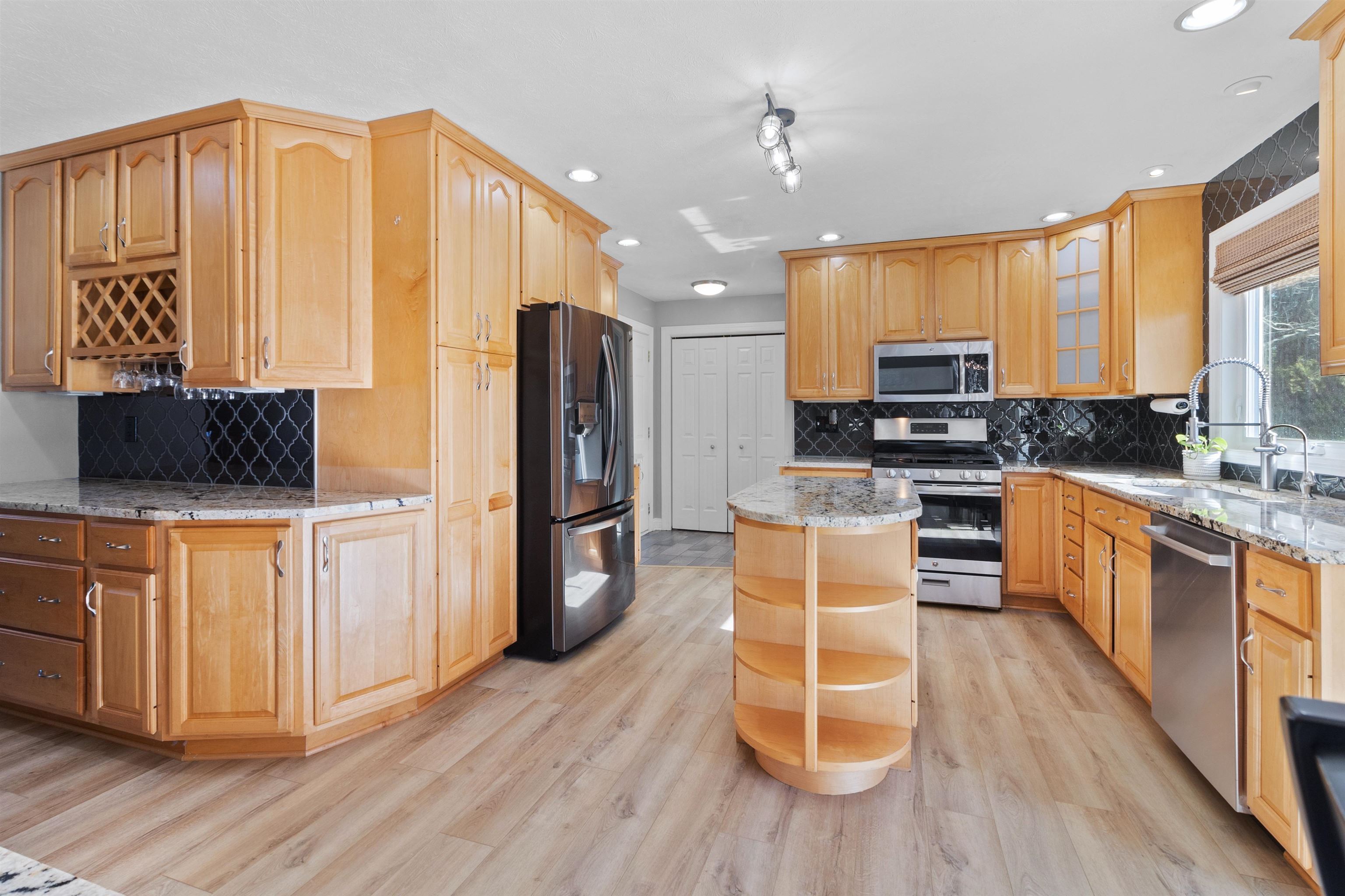 11857 Lerwick Road Caledonia, IL 61011 - Photo 32 of 72 a kitchen with stainless steel appliances wooden floors cabinets and a stove top oven