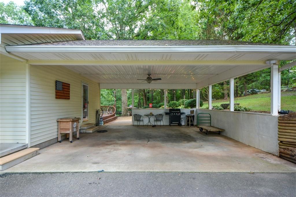 41 Clark Station Road Jasper, GA 30143 - Photo 11 of 69 a view of a patio with table and chairs potted plants with floor to ceiling window and tree