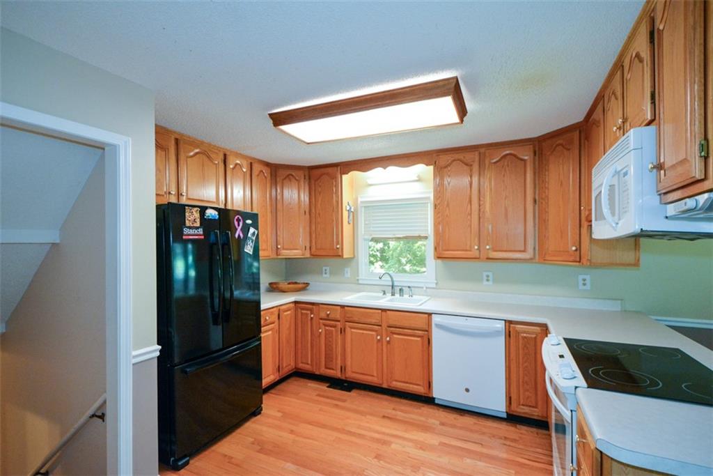 41 Clark Station Road Jasper, GA 30143 - Photo 25 of 69 a kitchen with a sink a refrigerator and cabinets