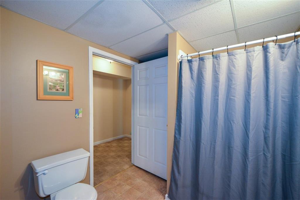 41 Clark Station Road Jasper, GA 30143 - Photo 35 of 69 a bathroom with a shower curtain and toilet