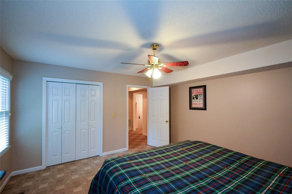 41 Clark Station Road Jasper, GA 30143 - Photo 39 of 69 a bedroom with a bed and a chandelier