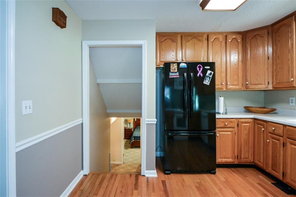 41 Clark Station Road Jasper, GA 30143 - Photo 44 of 69 a kitchen with a refrigerator and wooden floor