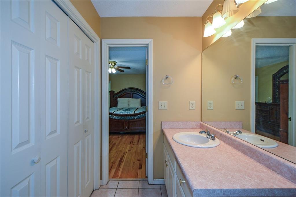 41 Clark Station Road Jasper, GA 30143 - Photo 48 of 69 a bathroom with a granite countertop sink and a mirror