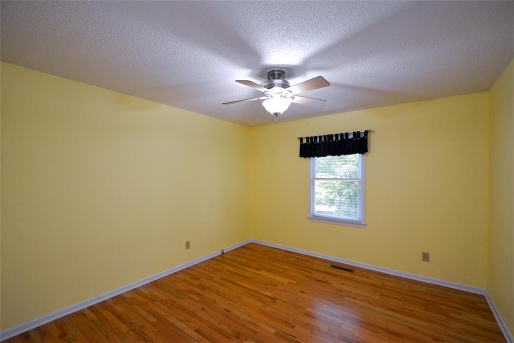 41 Clark Station Road Jasper, GA 30143 - Photo 55 of 69 a big room with wooden floor and a chandelier fan