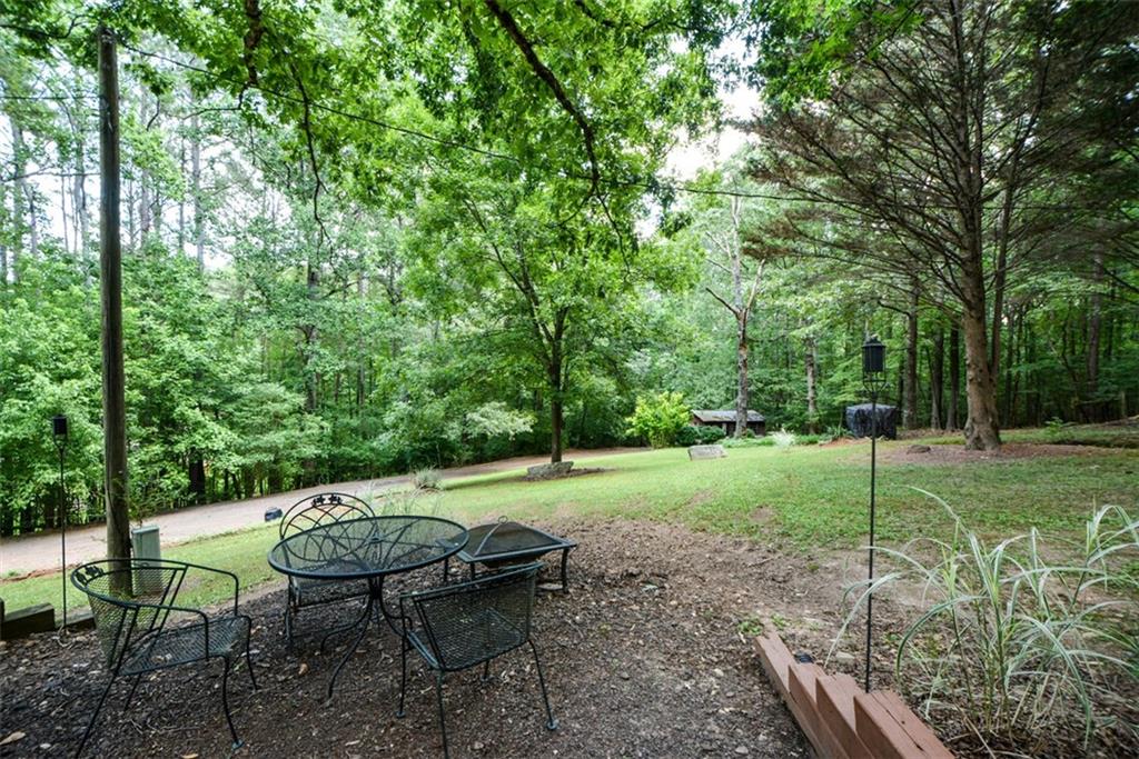 41 Clark Station Road Jasper, GA 30143 - Photo 61 of 69 a view of a table and chairs in backyard of the house