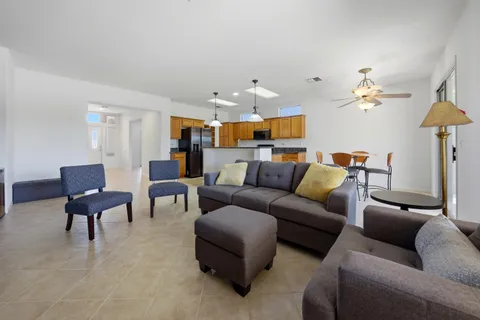 a living room with furniture and a chandelier