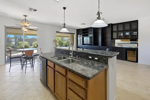 a kitchen with stainless steel appliances granite countertop a stove and a sink