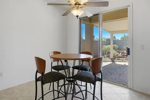 a view of a dining room with furniture and a potted plant
