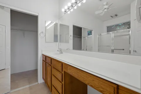 a bathroom with a sink a vanity and a large mirror
