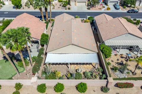 an aerial view of a house with a yard and potted plants