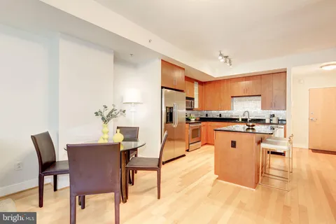 a living room with stainless steel appliances kitchen island granite countertop furniture and a kitchen view