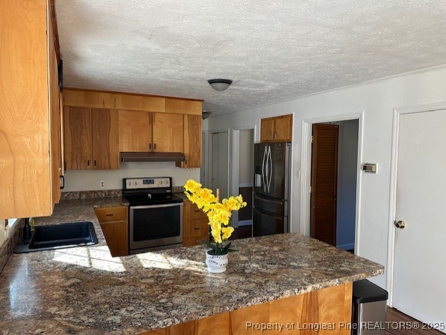 180 Castle Road Lumberton, NC 28358 - Photo 7 of 18 a kitchen with stainless steel appliances granite countertop a refrigerator and stove