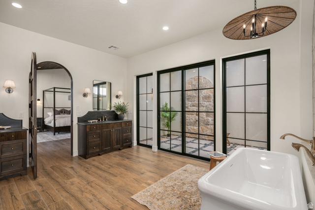 4871 South Homestead Way Washington, UT 84780 - Photo 44 of 151 Ensuite bathroom featuring vanity, dark wood-style floors, a tub to relax in, and recessed lighting