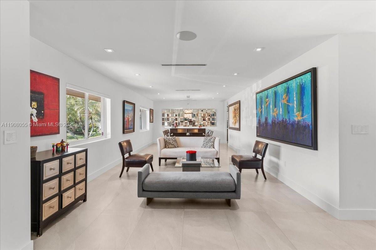 10105 Southwest 71st Avenue Pinecrest, FL 33156 - Photo 12 of 55 a living room with furniture a flat screen tv and a large window