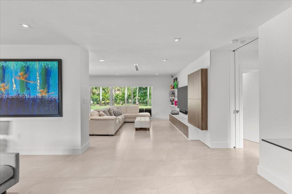 10105 Southwest 71st Avenue Pinecrest, FL 33156 - Photo 14 of 55 a living room with furniture and a large window