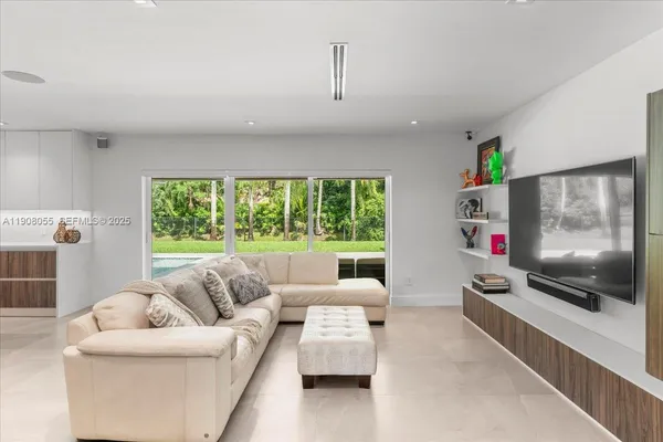 a large kitchen with a large counter top appliances and cabinets
