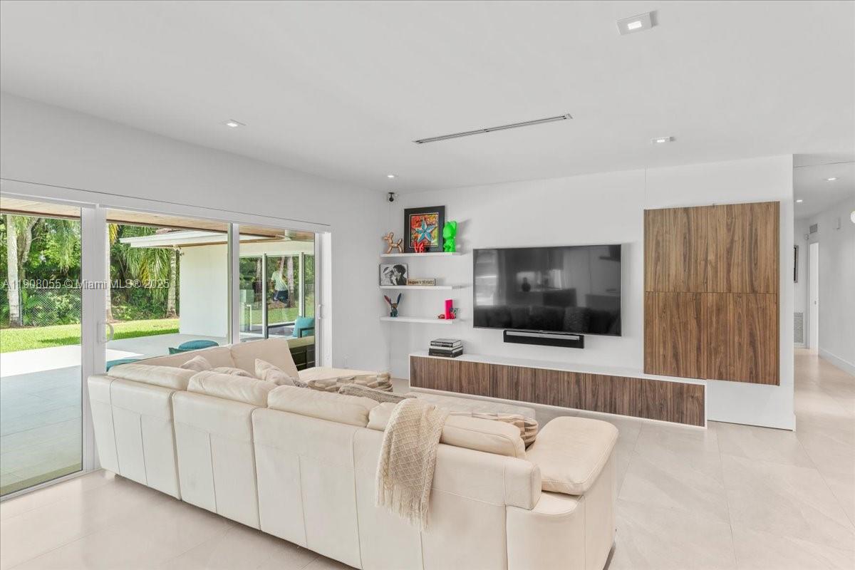 10105 Southwest 71st Avenue Pinecrest, FL 33156 - Photo 16 of 55 a living room with furniture and a flat screen tv