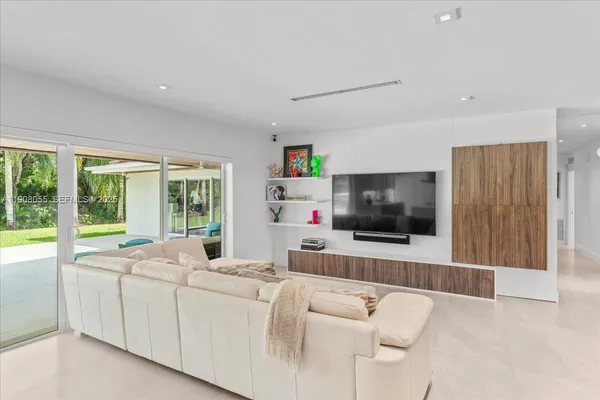 a large kitchen with a lot of counter space and wooden floor