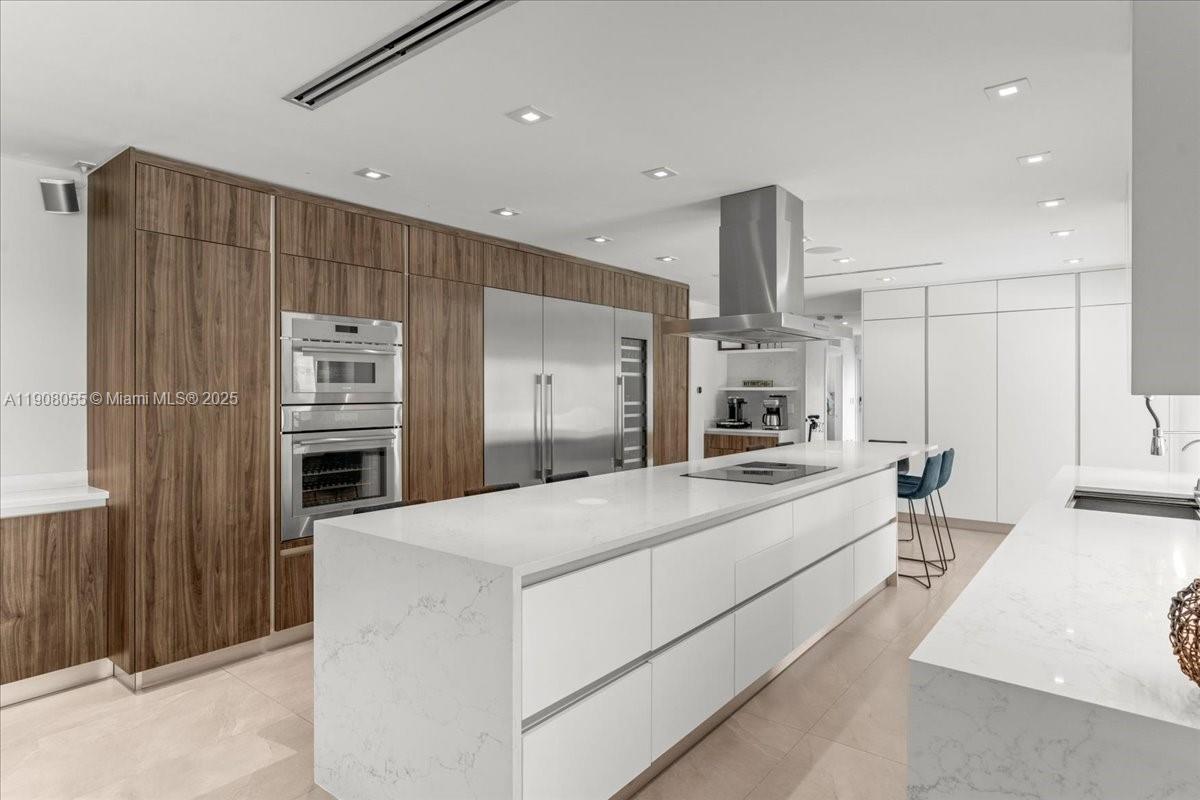 10105 Southwest 71st Avenue Pinecrest, FL 33156 - Photo 19 of 55 a large kitchen with a large counter top stainless steel appliances and cabinets