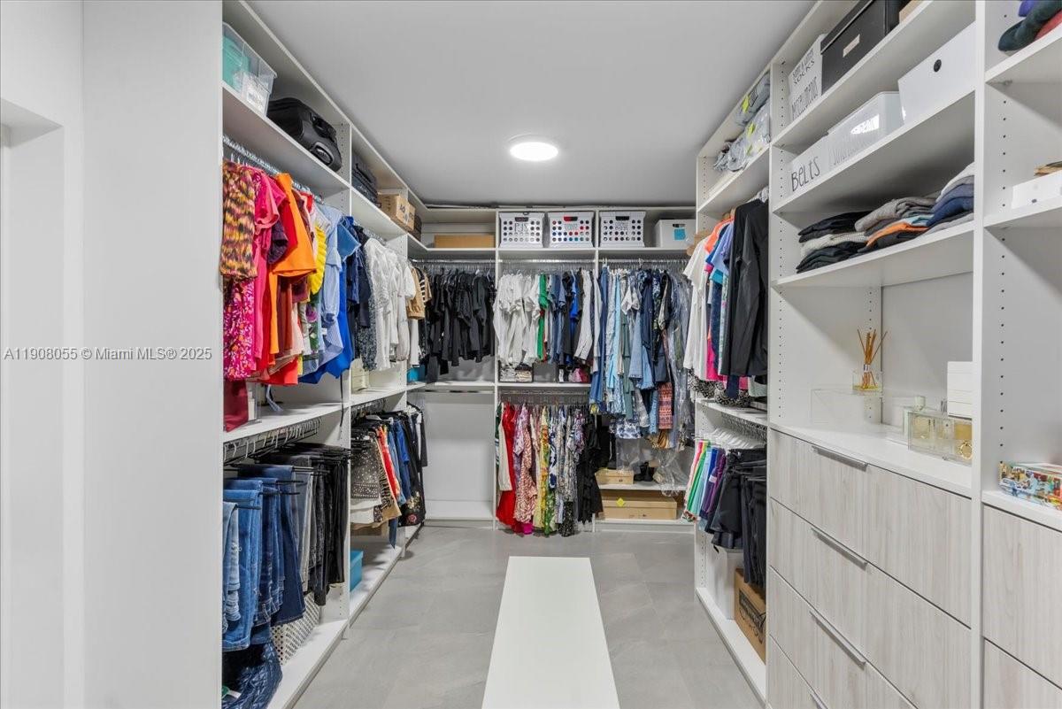 10105 Southwest 71st Avenue Pinecrest, FL 33156 - Photo 29 of 55 a view of walk in closet with clothes