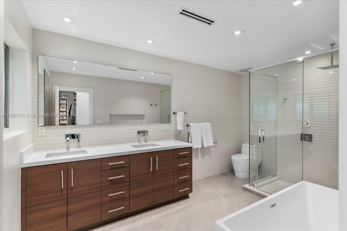 10105 Southwest 71st Avenue Pinecrest, FL 33156 - Photo 31 of 55 a spacious bathroom with a double vanity sink mirror double and shower
