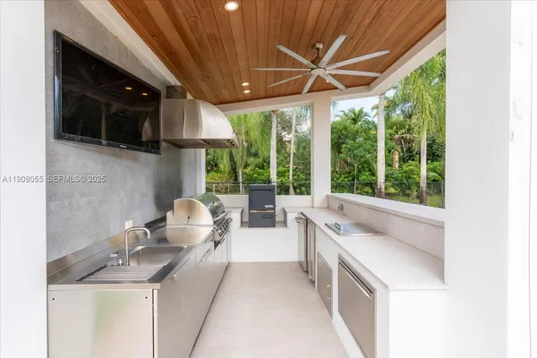 a view of a house with a patio and a yard