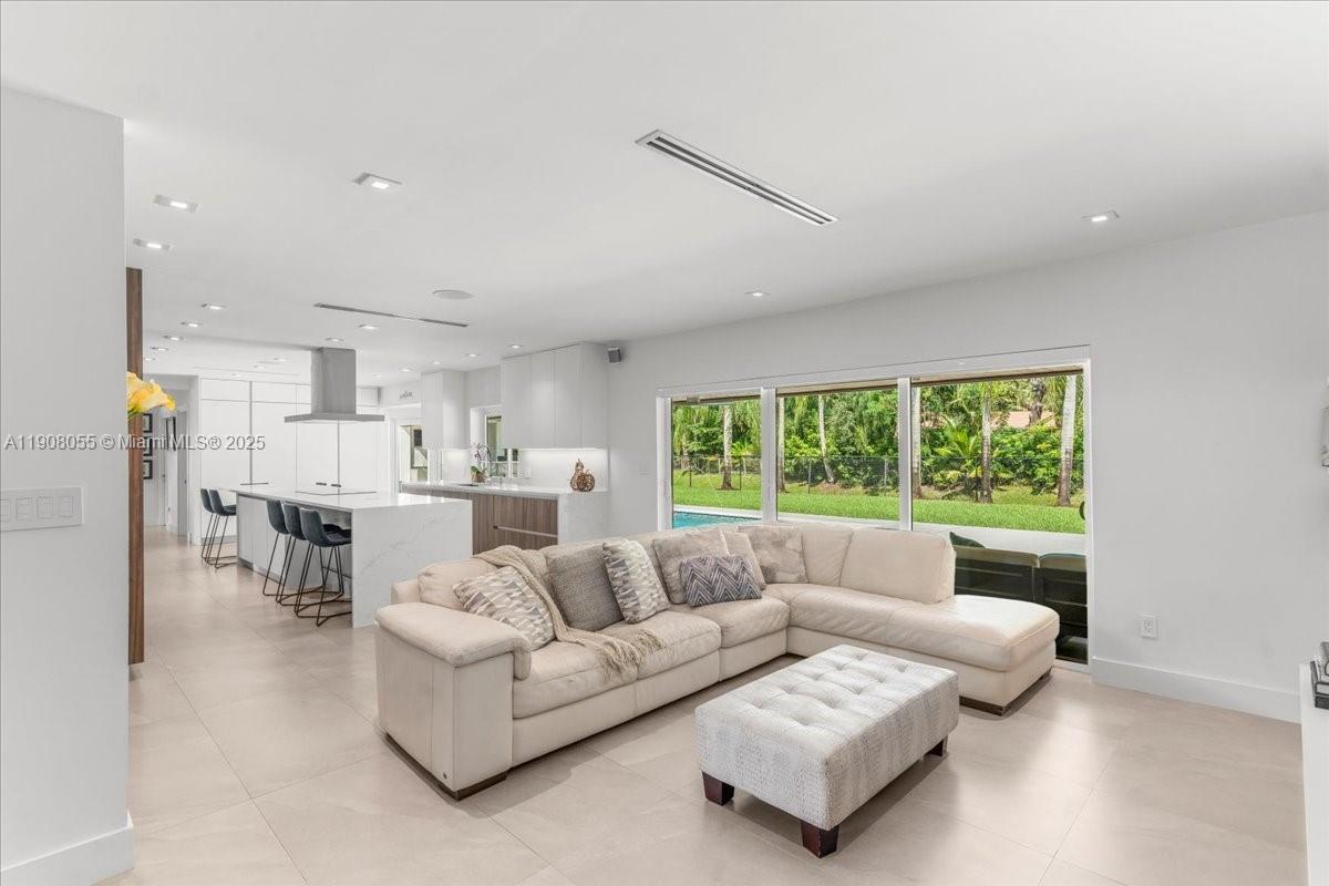 10105 Southwest 71st Avenue Pinecrest, FL 33156 - Photo 5 of 55 a living room with furniture and a large window