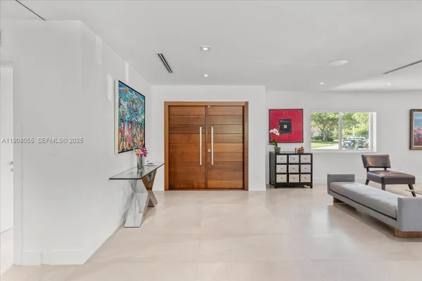 a dining room with furniture window and wooden floor