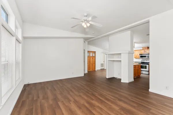a kitchen with stainless steel appliances granite countertop a stove a sink and a microwave
