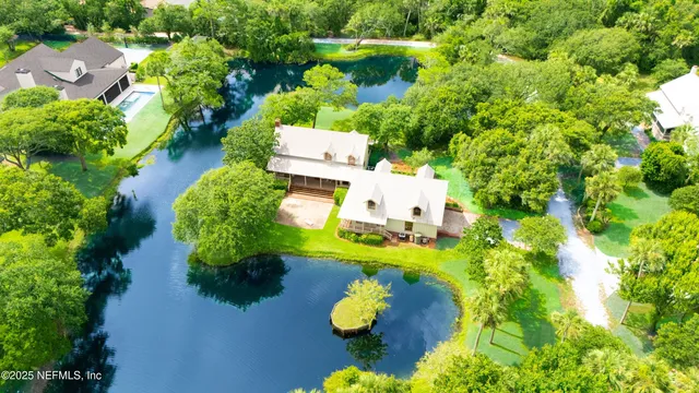 an aerial view of residential house with yard and swimming pool