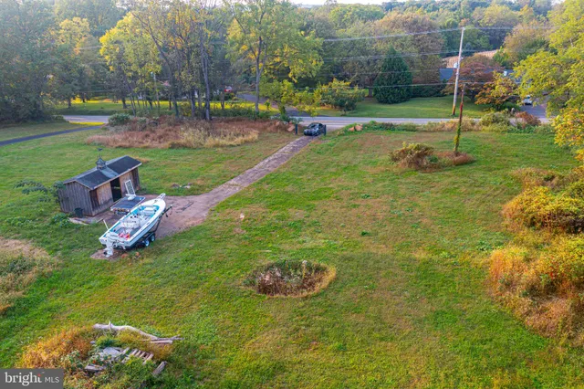 a house view with swimming pool in front of the house