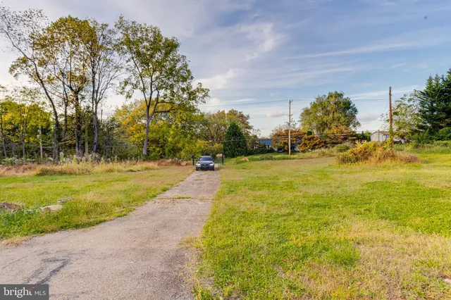 a view of yard with swimming pool and trees