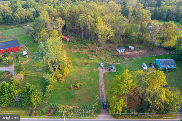 a backyard of a house with a yard and outdoor seating