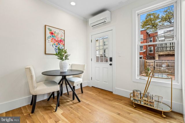 a view of a workspace with furniture window and wooden floor