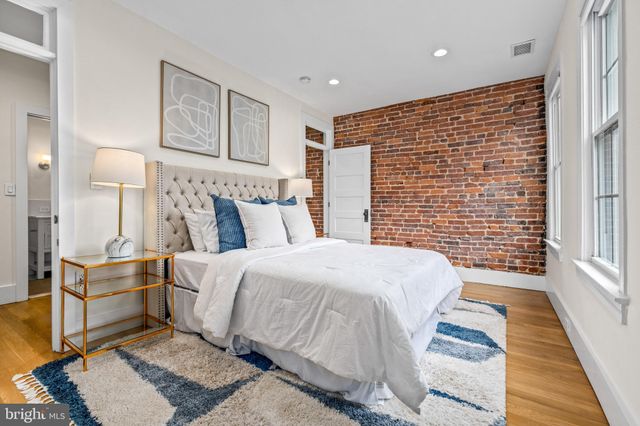 a bed room with a bed and a night stand