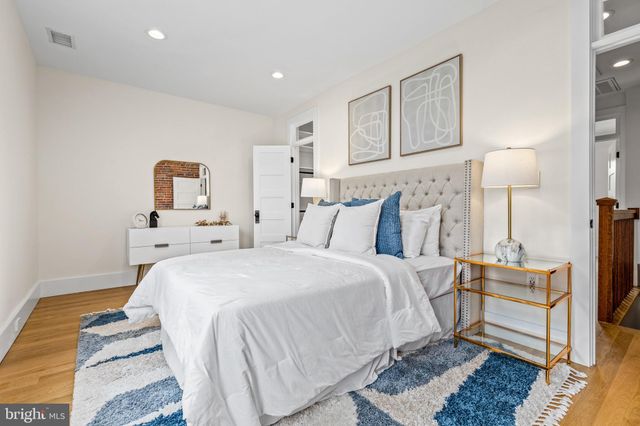 a bed sitting in a bedroom next to a window