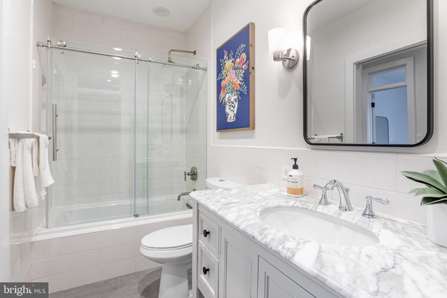 a bedroom with a bed and a table