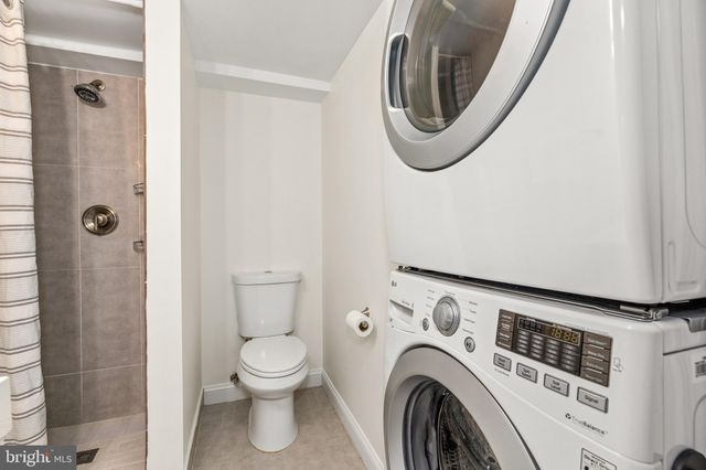 a view of a house with backyard and wooden fence