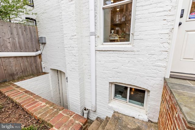 a picture of a bench in front of a window