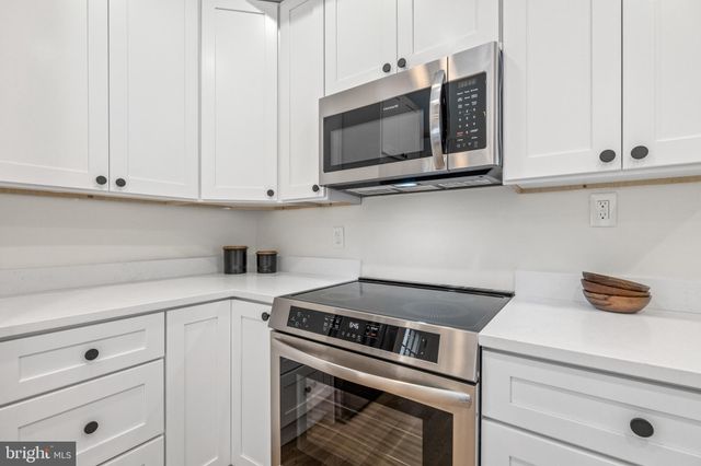 a kitchen with a stove and a microwave