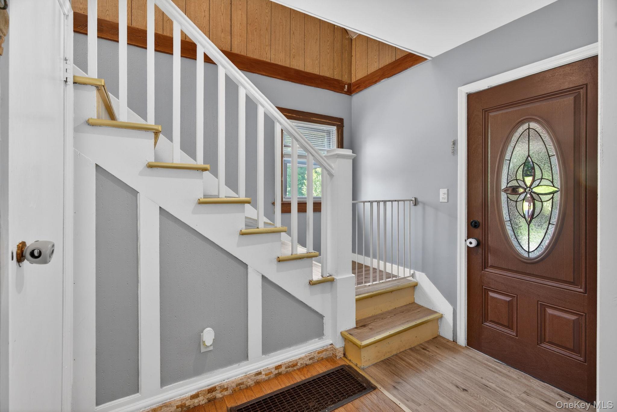 7 Walnut Street Poughkeepsie, NY 12601 - Photo 7 of 30 The staircase, gracefully ascending to the second level, serves as an attractive focal point, creating an inviting flow throughout the home while enhancing the classic charm of the interior.