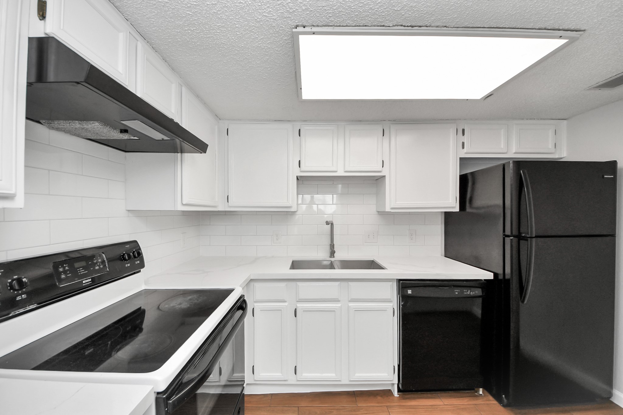 3750 Tanglewilde Street, Unit A7 Houston, TX 77063 - Photo 18 of 41 a kitchen with white cabinets and a stove top oven