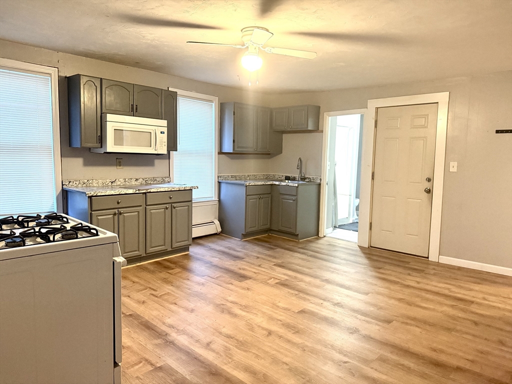 45 Mitchell Street, Unit 1 New Bedford, MA 02746 - Photo 4 of 11 a kitchen with stainless steel appliances granite countertop a stove a sink and a refrigerator