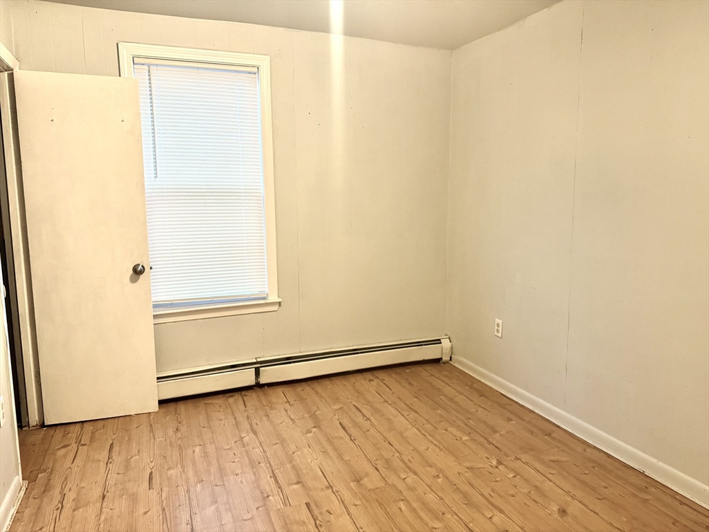 45 Mitchell Street, Unit 1 New Bedford, MA 02746 - Photo 10 of 11 a view of a room with wooden floor and a window