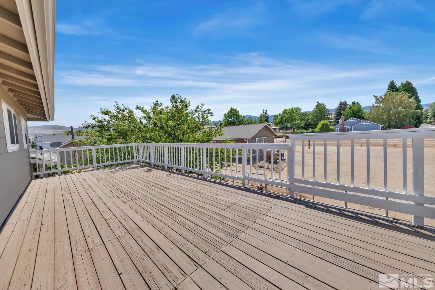 12955 Valley Springs Road Reno, NV 89511 - Photo 17 of 40 a view of deck with wooden floor and fence with a large garden