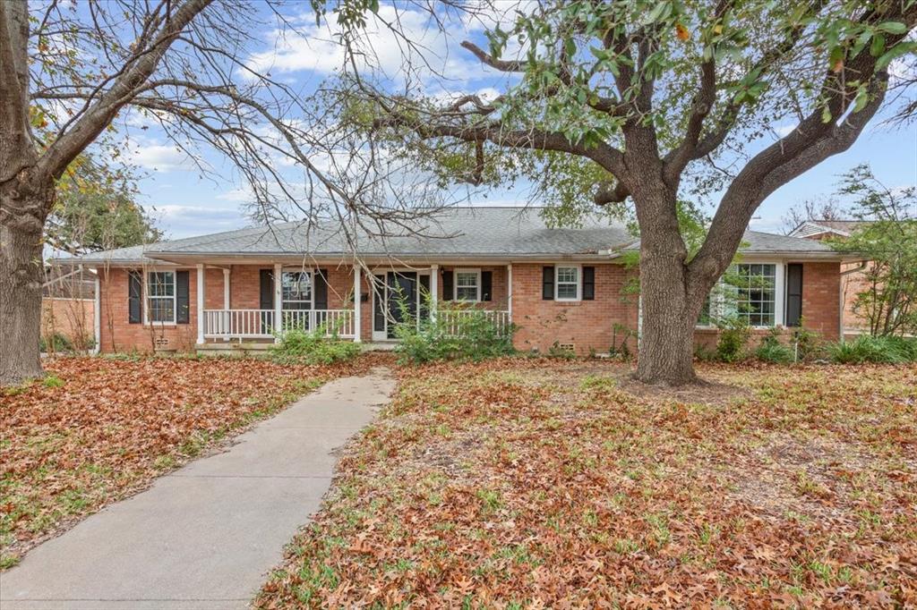 front view of a house with a tree in front of it