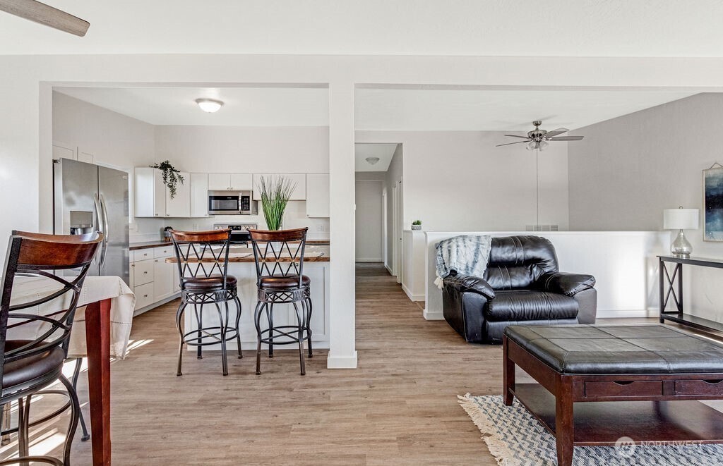 128 West Nelson Road Moses Lake, WA 98837 - Photo 23 of 37 a living room with furniture and a wooden floor
