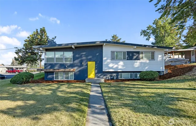 a front view of house with yard and green space